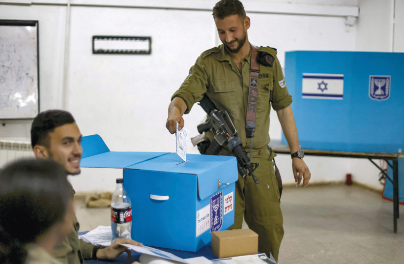  A soldier casts his ballot in the Israeli general elections a day early at the Har Dov military base on Mount Hermon, on October 31, 2022.  (photo credit: JALAA MAREY/AFP VIA GETTY IMAGES)