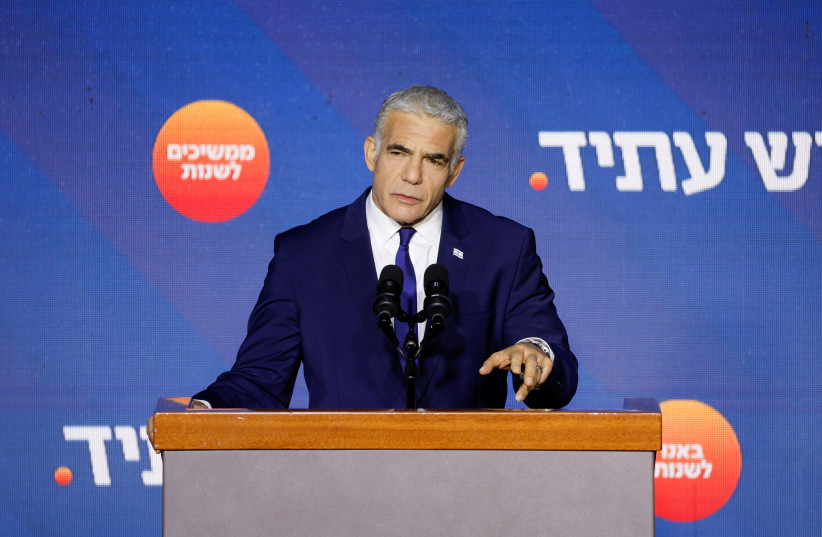  Israeli Prime Minister and Yesh Atid party leader Yair Lapid addresses his supporters from the stage at his party headquarters during Israel's general election in Tel Aviv, Israel, November 2, 2022. (photo credit: REUTERS/AMIR COHEN)