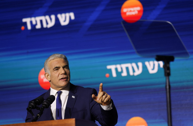  Israeli Prime Minister and Yesh Atid party leader Yair Lapid addresses his supporters from the stage at his party headquarters during Israel's general election in Tel Aviv, Israel November 2, 2022. (photo credit: REUTERS/NIR ELIAS)