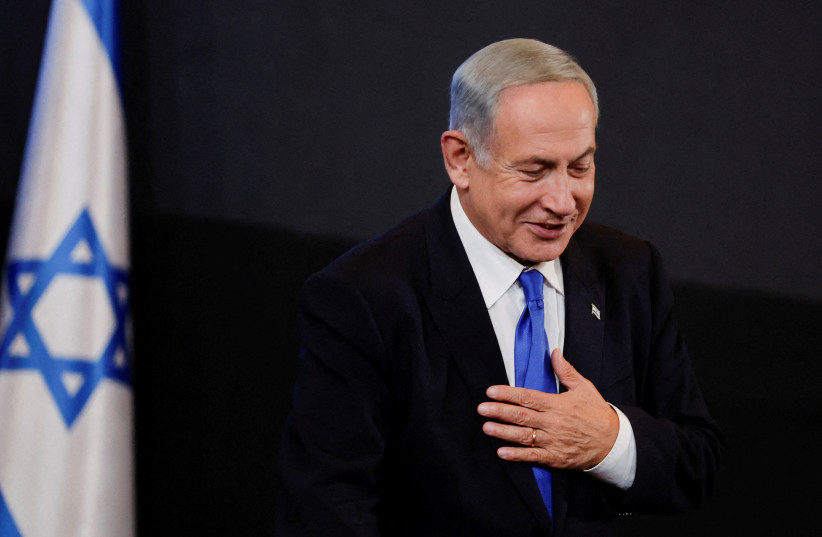 Likud party leader Benjamin Netanyahu gestures to his supporters at his party headquarters during Israel's general election in Jerusalem, November 2, 2022. (photo credit: REUTERS/AMMAR AWAD)