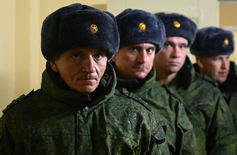  Russian reservists recruited during the partial mobilisation of troops line up as they receive gear before departing to the zone of Russia-Ukraine conflict, in the Rostov region, Russia October 31, 2022 (credit: REUTERS/SERGEY PIVOVAROV)