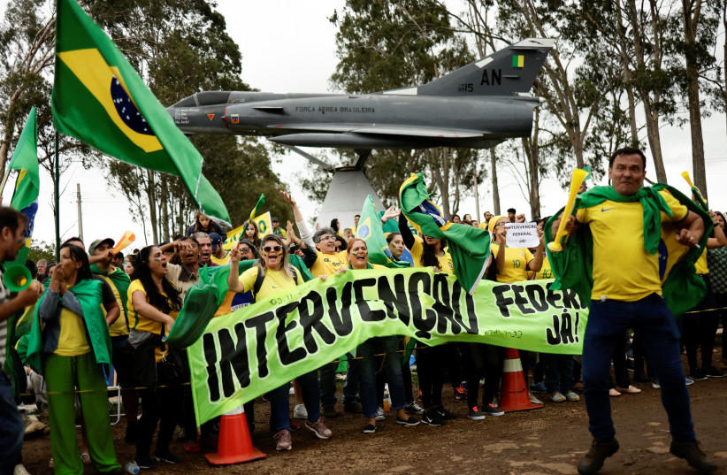  People attend a protest over Brazil's President Jair Bolsonaro's defeat in the presidential run-off election, in Anapolis, Goias state, Brazil, November 2, 2022. (photo credit: REUTERS/UESLEI MARCELINO)