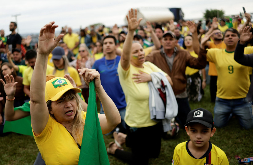  People pray during a protest over Brazil's President Jair Bolsonaro's defeat in the presidential run-off election, in Anapolis, Goias state, Brazil, November 2, 2022.  (credit: REUTERS/UESLEI MARCELINO)