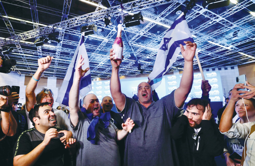  LIKUD SUPPORTERS break out the champagne following the results of the exit polls on Election Day. (photo credit: MARC ISRAEL SELLEM/THE JERUSALEM POST)