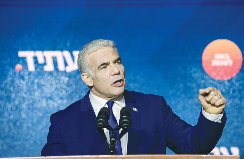  Prime Minister and leader of the Yesh Atid party Yair Lapid speaks to supporters in Tel Aviv late Tuesday night, after preliminary election results were announced. (photo credit: TOMER NEUBERG/FLASH90)