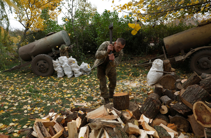  A Ukrainian serviceman staying in a village close to the front line, chops wood for stoves as fuel for heating and cooking, as Russia's invasion of Ukraine continues, in Donetsk region, Ukraine, October 29, 2022. (credit: CLODAGH KILCOYNE/REUTERS)