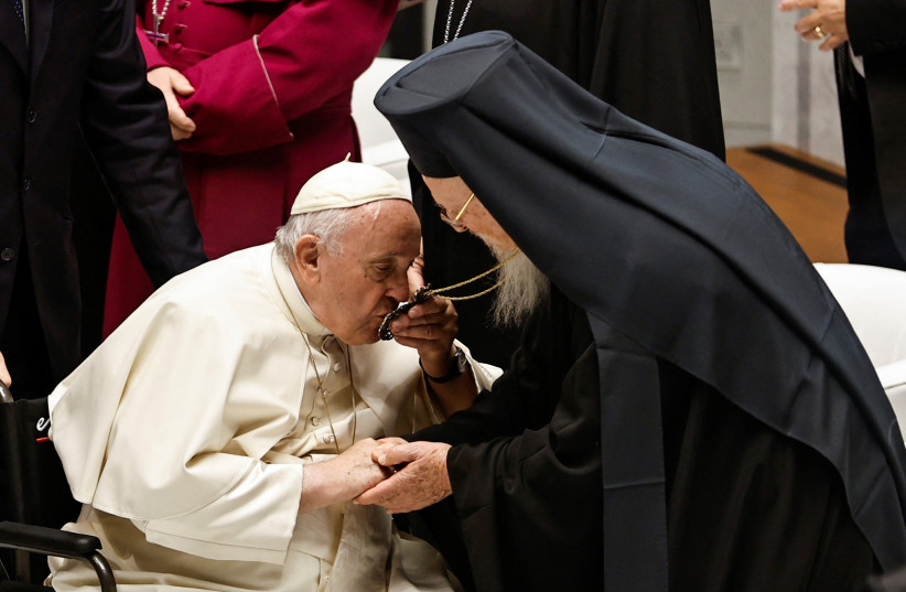  Pope Francis kisses the pendant of Ecumenical Patriarch Bartholomew I, as the Pope holds an ecumenical meeting and prayer for peace at Our Lady of Arabia Cathedral, in Awali, Bahrain (photo credit: REUTERS)