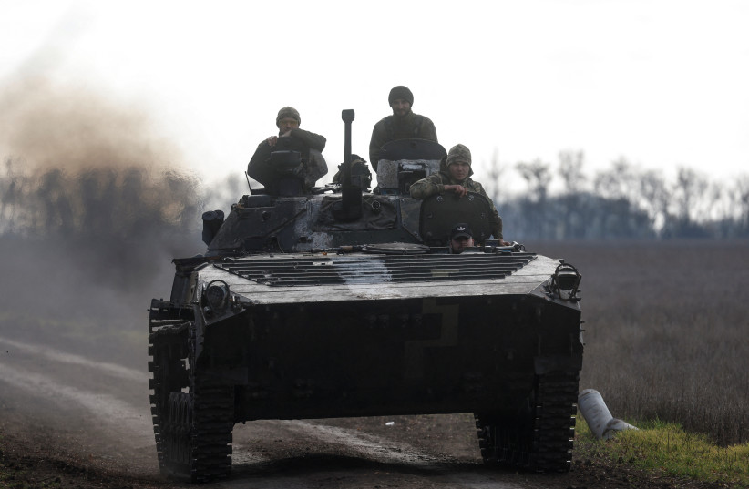  Ukrainian servicemen ride an armoured fighting vehicle, amid Russia's attack on Ukraine, in a frontline in Mykolaiv region, Ukraine (photo credit: REUTERS)