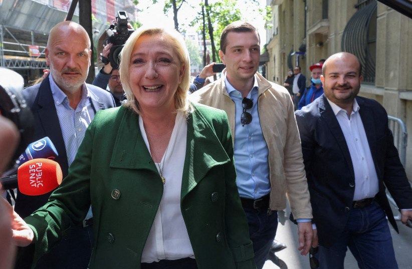 Marine Le Pen, French far-right National Rally ccompanied by RN party acting president Jordan Bardella and RN party member David Rachline in Paris, France, April 25, 2022. (credit: REUTERS/YVES HERMAN)