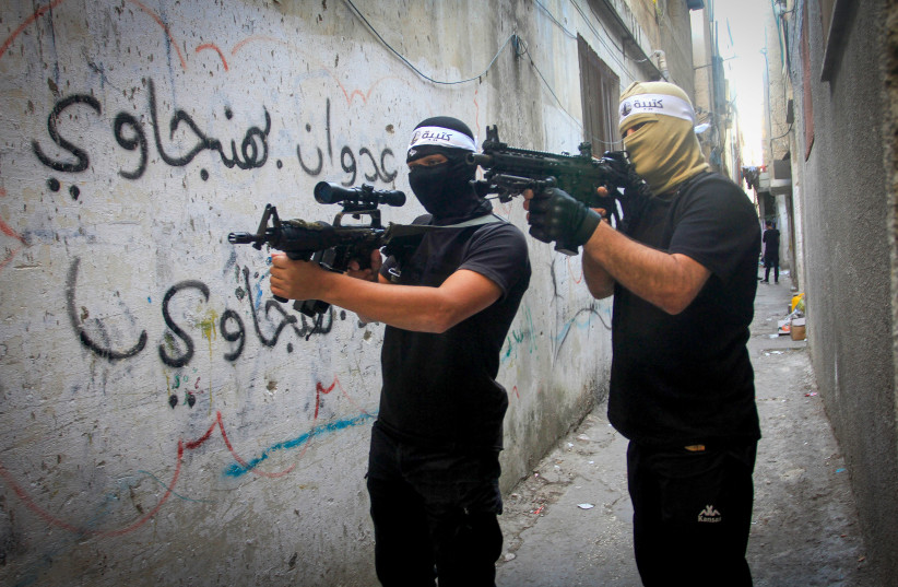  Palestinian gunmen from the Balata Brigade of the Fatah movement carry their weapons during a military parade, in Balata refugee camp, in the West Bank, on November 4, 2022.  (credit: NASSER ISHTAYEH/FLASH90)