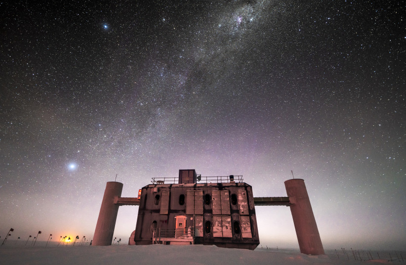  Front view of the IceCube Lab at twilight, with a starry sky showing a glimpse of the Milky Way overhead and sunlight lingerin​​g on the horizon (photo credit: Martin Wolf, IceCube/NSF)