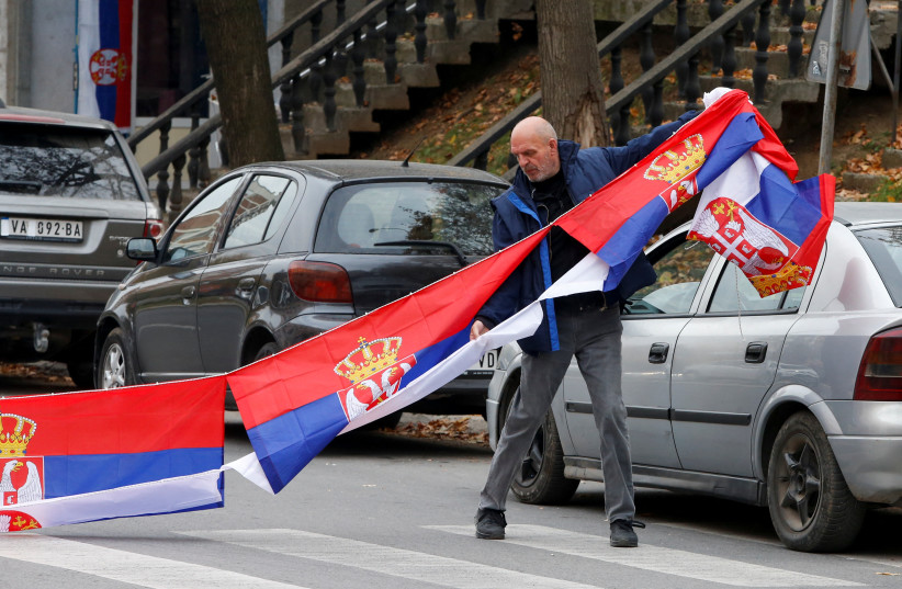  A man holds Serbian flags following local Serbs' decision to leave Kosovo institutions, in North Mitrovica, Kosovo, November 5, 2022. (credit: OGNEN TEOFILOVSKI/REUTERS)