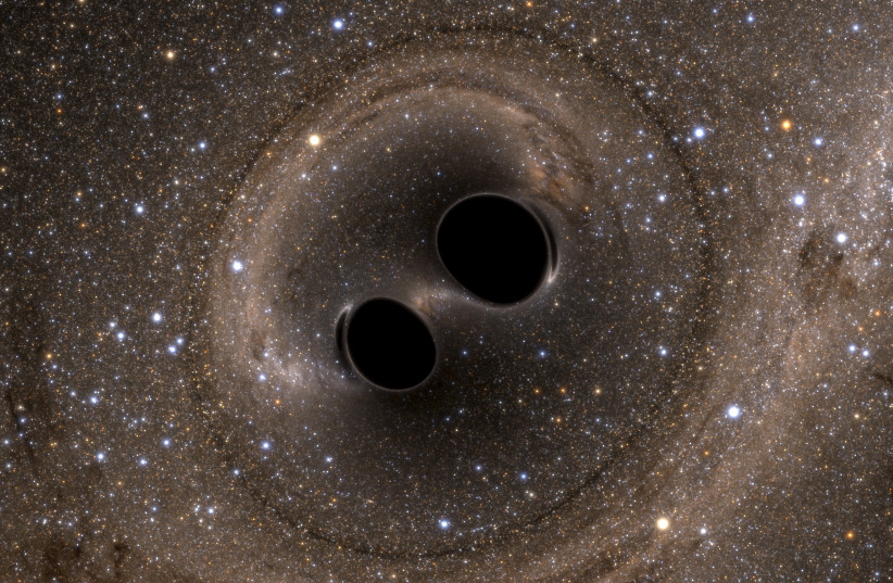  The collision of two black holes - a tremendously powerful event detected for the first time ever by the Laser Interferometer Gravitational-Wave Observatory, or LIGO - is seen in this still image from a computer simulation released in Washington February 11, 2016 (photo credit: REUTERS/The SXS (Simulating eXtreme Spacetimes)/Handout via Reuters)