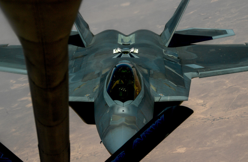  A US Air Force F-22 Raptor based out of Al Udeid Air Base, Qatar, prepares to connect with a KC-135 Stratotanker during an aerial refueling mission above an undisclosed location in the Gulf, in this undated handout picture released by US Air Force on August 1, 2019. (credit: CHRIS DRZAZGOWSKI/US AIRFORCE/HANDOUT VIA REUTERS)