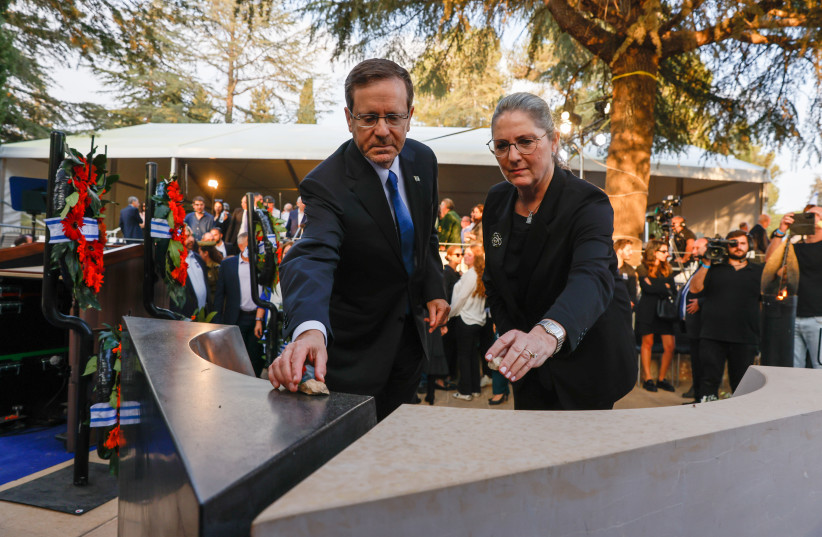  Israeli president Isaac Herzog and his wife Michal at a memorial service marking 27 years since the assasination of late Israeli prime minister Yitzhak Rabin, held at Mount Herzl cemetery in Jerusalem on November 6, 2022. (photo credit: OLIVIER FITOUSSI/FLASH90)