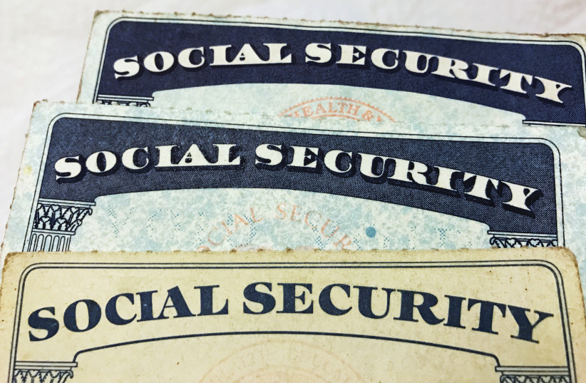  SOCIAL SECURITY card designs over the past several decades are shown in this photo illustration. (photo credit: Hyungwon Kang/Reuters)