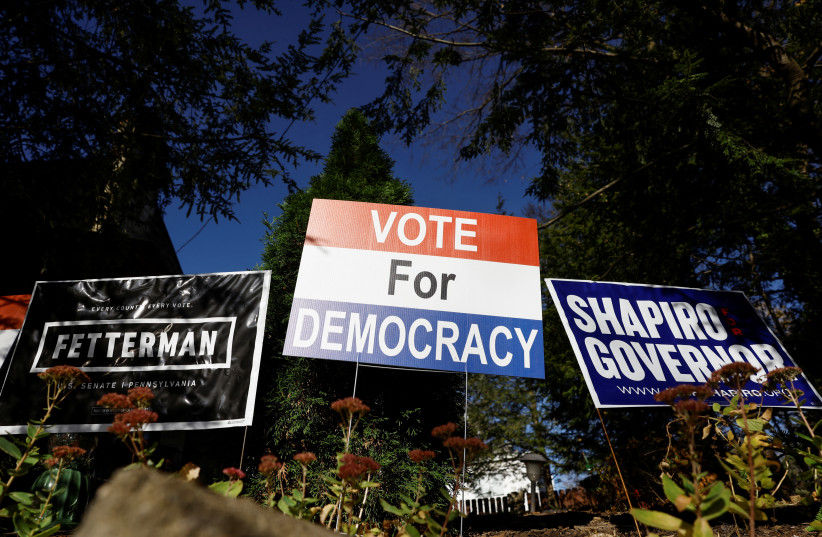  Voting and campaign signs are displayed during the 2022 US midterm elections, in Pittsburgh, Pennsylvania, US, November 8, 2022 (photo credit: REUTERS/QUINN GABLICKI)