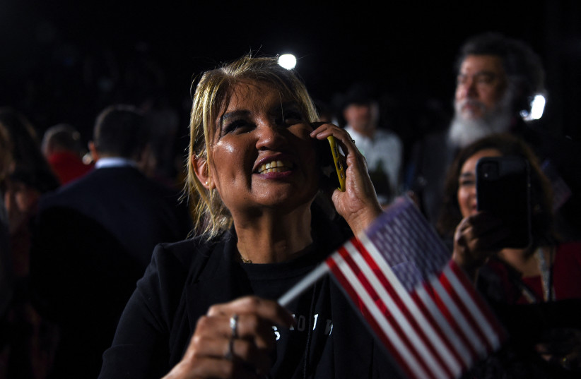  A supporter speaks on phone as she attends Republican Governor Greg Abbott's 2022 US midterm elections night party in McAllen, Texas, US, November 8, 2022. (photo credit: CALLAGHAN O'HARE/REUTERS)