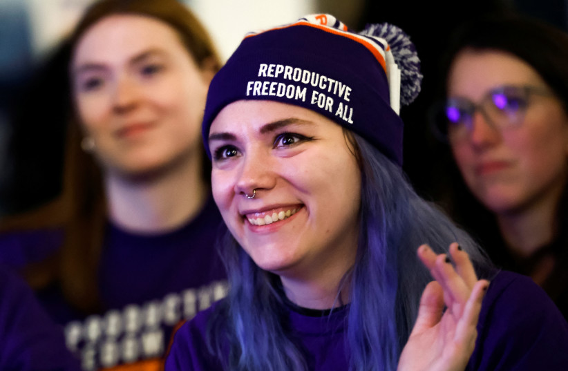 Women cheer as they hear early voting results indicating the passage of Proposal 3, a midterm ballot measure that enshrines abortion rights, during a Reproductive Freedom For All watch party on US midterm election night in Detroit, Michigan, November 8, 2022.  (credit: EVELYN HOCKSTEIN/REUTERS)