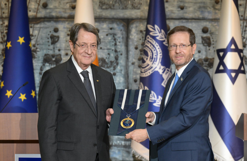  President Issac Herzog awards Cypriot counterpart Nicos Anastasiades with a Presidential Medal of Honor on November 9, 2022 (photo credit: AMOS BEN-GERSHOM/GPO)
