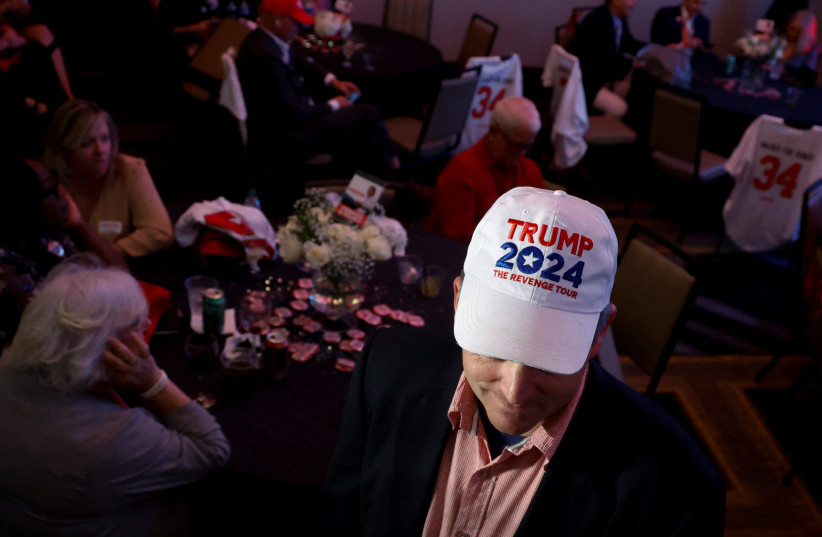  An attendee wears a Trump 2024 hat during Georgia Republican candidate for US Senate Herschel Walker's 2022 US midterm election night party in a ballroom at the Omni Hotel in Atlanta, Georgia, US November 8, 2022 (credit: REUTERS/JONATHAN ERNST)