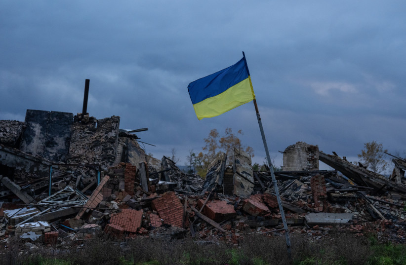  A Ukrainian flag flies above the ruins of buildings destroyed during fighting between Ukrainian and Russian occupying forces, on October 24, 2022 in Kam'yanka, Kharkiv oblast, October 24, 2022. (photo credit: CARL COURT/GETTY IMAGES)