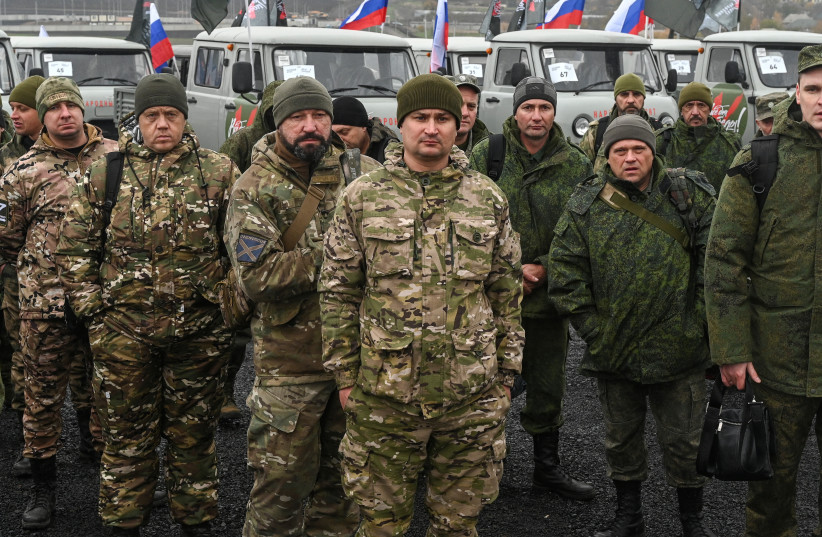  Members of the people's militia of the Donetsk and Lugansk (Luhansk) regions, which is part of the Russian armed forces, take part in a ceremony to receive UAZ off-road vehicles in the course of Russia-Ukraine conflict, in the Rostov region, Russia November 4, 2022. (photo credit: REUTERS/SERGEY PIVOVAROV)