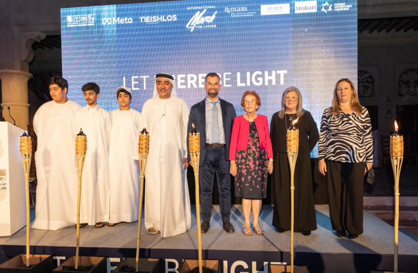  Emirati children lit a torch of hope together with Holocaust survivor and witness to Kristallnacht, Eve Kugler, at an event in Dubai commemorating the 84th anniversary of Kristallnacht. (credit: MARCH OF THE LIVING)