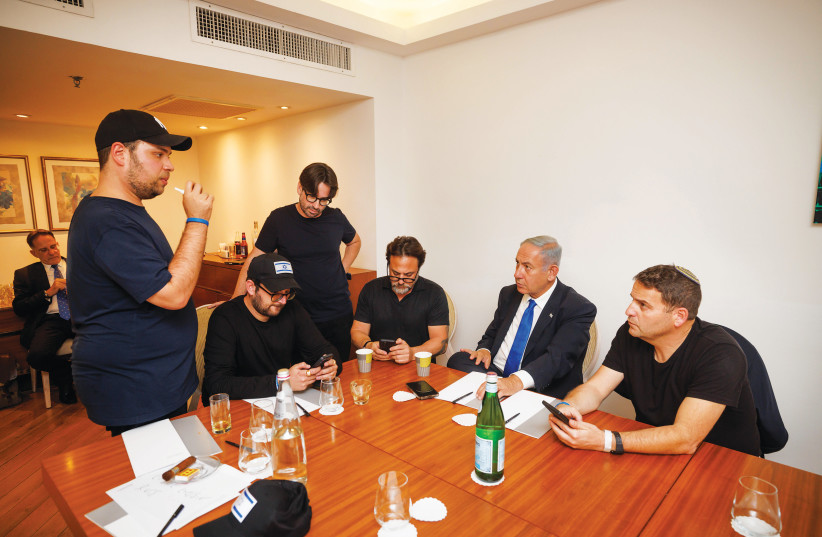  TEN MINUTES before the 10 p.m. exit poll announcements on election night, Benjamin Netanyahu and advisers, including the writer (standing center), consult and anticipate developments. (photo credit: ZIV KOREN)