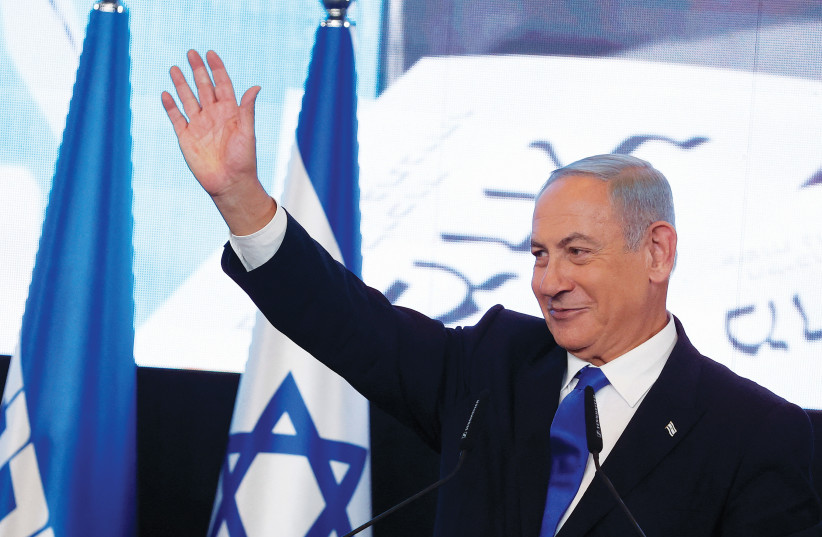  BENJAMIN NETANYAHU waves to supporters at Likud headquarters on election night, last week. For the Right, this is a time to show the world that the right hand of God is not of harsh judgment but of love, says the writer. (credit: AMMAR AWAD/REUTERS)
