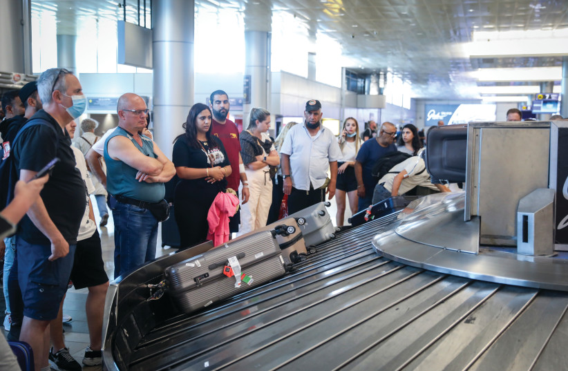  TRAVELERS ARRIVING at Ben-Gurion Airport – looking forward to seeing which airlines buck the trend and state clearly that while they cannot waive an outright cancellation fee, a change fee can be made at no cost. (photo credit: NOAM REVKIN FENTON/FLASH90)