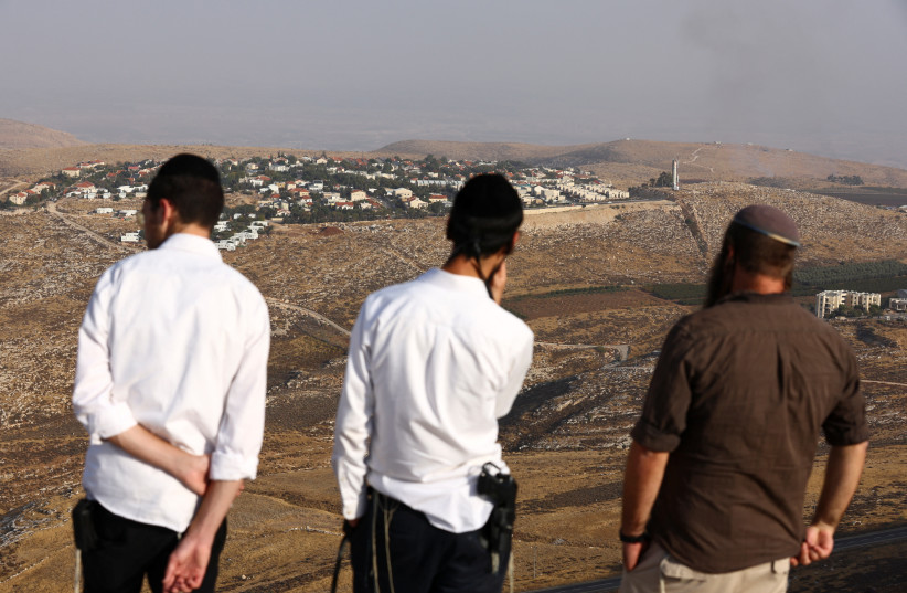 People overlook the Jewish settlement of Kokhav Hashahar, in the West Bank during a scouting mission to find new hilltops to settle, November 6, 2022. (credit: RONEN ZVULUN/REUTERS)