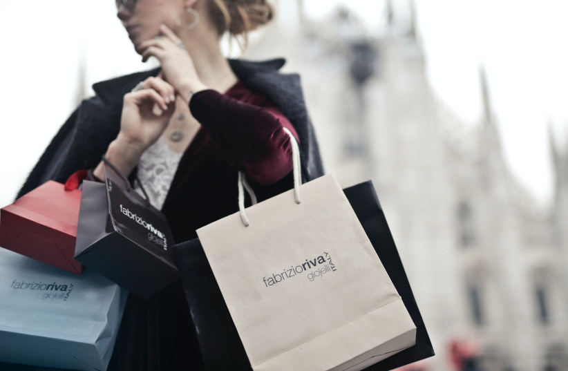  Person holding shopping bags (illustrative) (photo credit: PEXELS)