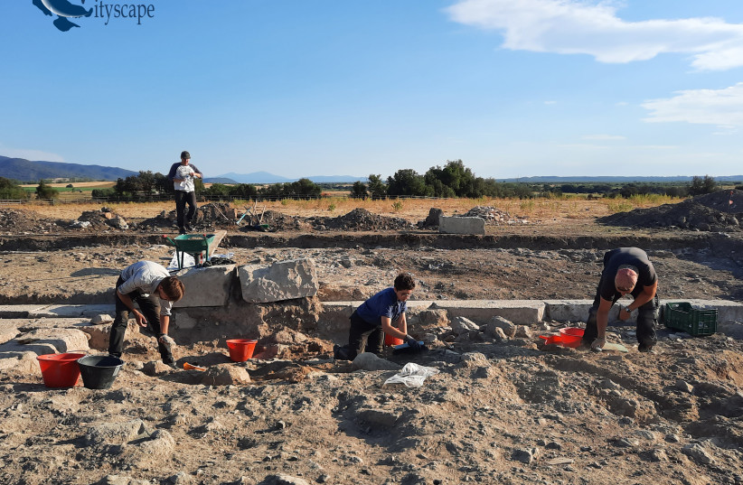 Archaeologists and other colleagues uncover the walls of the Etruscan temple in Vulci.  (credit: MARIACHIARA FRANCESCHINI VIA VULCI CITYSCAPE)