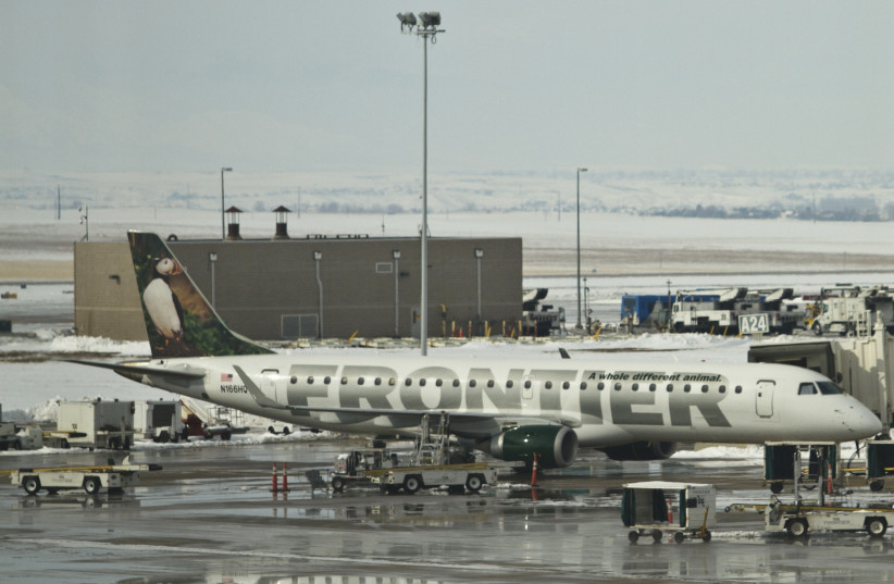  A Frontier Airlines jet waits at the gate prior to departure at the Denver International Airport in Denver, Colorado, February 4, 2012. (credit: REUTERS/Nathan Armes)