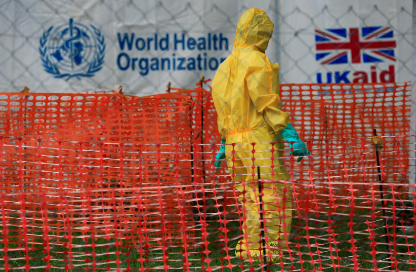  A person dressed in ebola protective apparel is seen inside an ebola care facility at the Bwera general hospital near the border with the Democratic Republic of Congo in Bwera (photo credit: REUTERS)