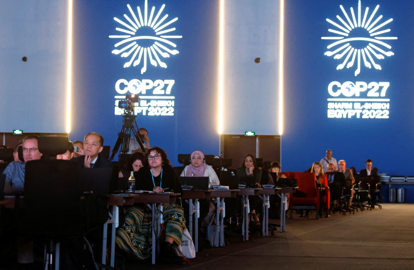  People listen as they attend the COP27 climate summit at the Red Sea resort of Sharm el-Sheikh, Egypt November 9, 2022. (credit: REUTERS/MOHAMMED SALEM)