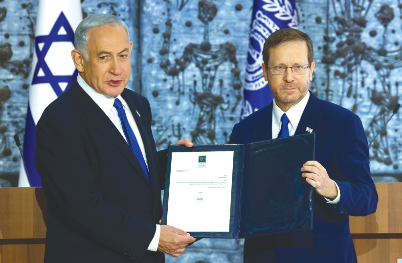  PRESIDENT ISAAC Herzog presents a letter to MK Benjamin Netanyahu, giving him a mandate to try to form a government coalition, at the President’s Residence in Jerusalem, on Sunday (photo credit: MARC ISRAEL SELLEM/THE JERUSALEM POST)