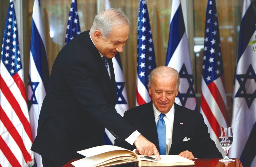  THEN-US vice president Joe Biden prepares to sign the guest book before his meeting with then-prime minister Benjamin Netanyahu at the Prime Minister’s Residence in Jerusalem in 2010 (photo credit: RONEN ZVULUN/REUTERS)