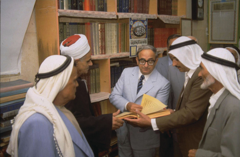  EXAMINING SACRED books of Islam with distinguished leaders of the city of Taybeh, 1980. (credit: YAAKOV SAAR/GPO)