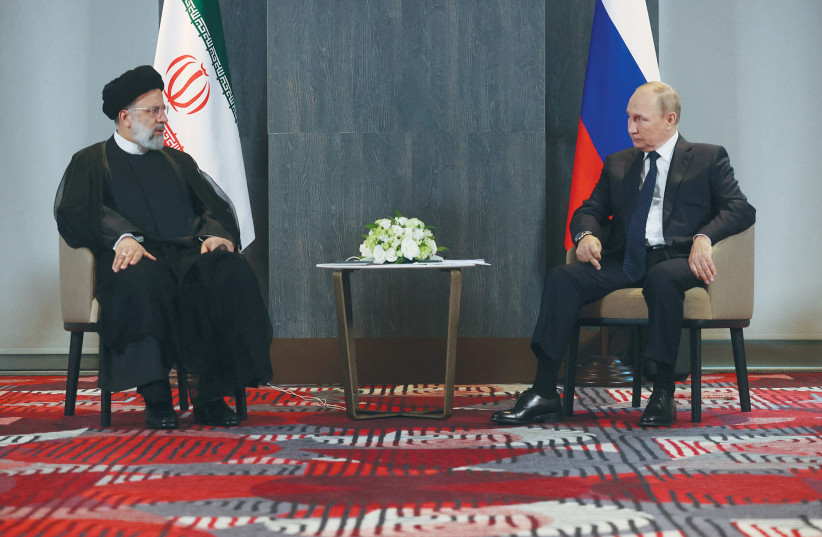  RUSSIAN PRESIDENT Vladimir Putin meets with Iranian President Ebrahim Raisi on the sidelines of the Shanghai Cooperation Organization summit in Uzbekistan, in September. (photo credit: SPUTNIK/REUTERS)