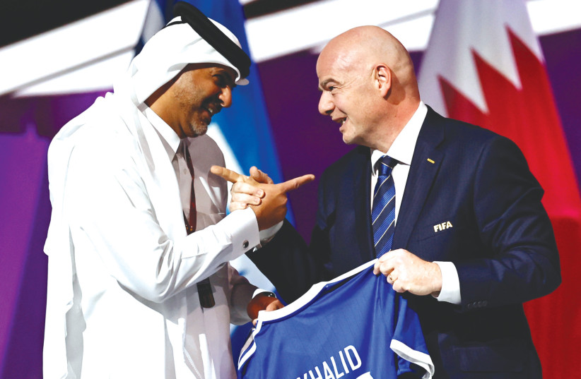  FIFA PRESIDENT Gianni Infantino and Qatari Prime Minister Sheikh Khalid bin Khalifa bin Abdul Aziz al-Thani hold a shirt during the FIFA Congress in Doha in March.  (photo credit: HAMAD I MOHAMMED/REUTERS)