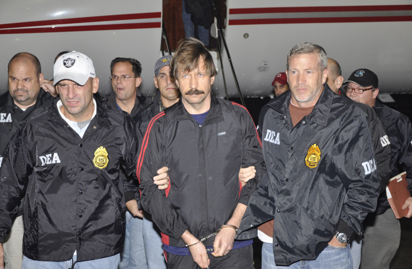  Russian arms dealer Viktor Bout (center) is escorted by Drug Enforcement Administration officers after arriving at Westchester County Airport in White Plains, New York, November 16, 2010.  (photo credit: REUTERS/US DEPARTMENT OF JUSTICE/HANDOUT)