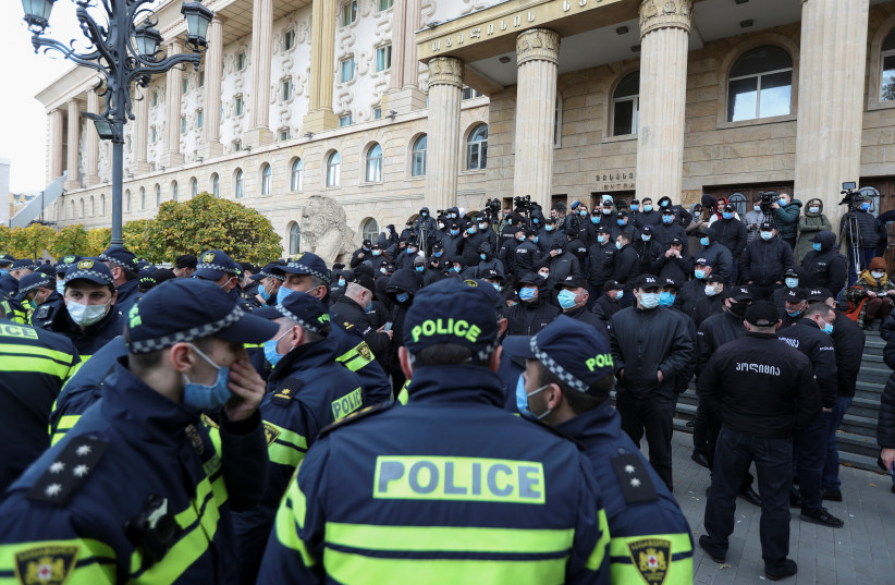  Police officers guard an area outside a court building during a hearing of the case against former Georgian President Mikheil Saakashvili, who was detained after his return to the country, in Tbilisi, Georgia November 10, 2021 (photo credit: REUTERS/IRAKLI GEDENIDZE)
