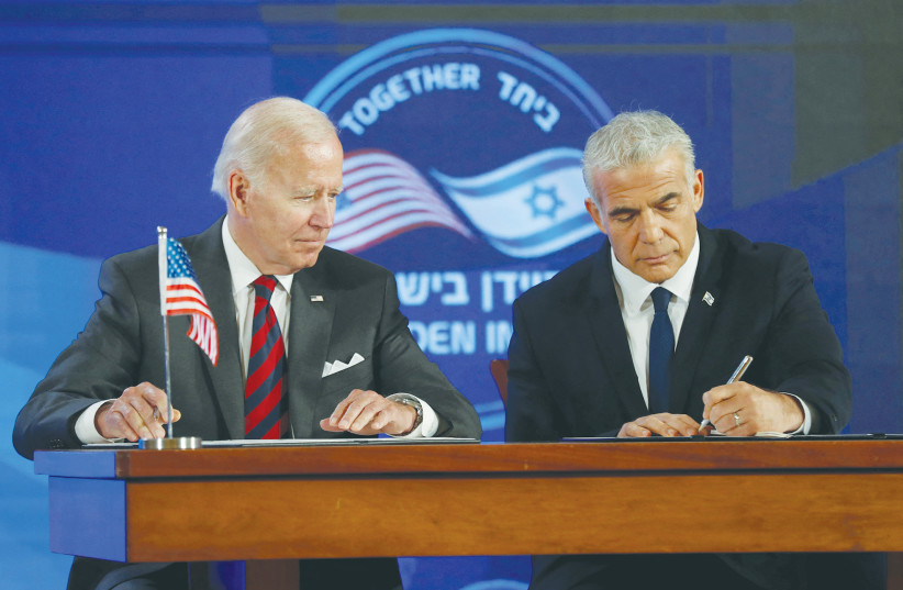  PRIME MINISTER Yair Lapid and US President Joe Biden sign a security pledge in Jerusalem, in July. (photo credit: ATEF SAFADI/REUTERS)