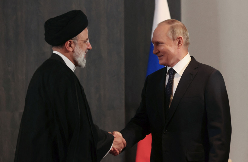 Russian President Vladimir Putin shakes hands with Iranian President Ebrahim Raisi during a meeting on the sidelines of the Shanghai Cooperation Organization (SCO) summit in Samarkand (photo credit: REUTERS)