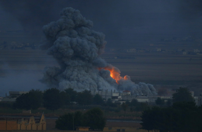  Smoke rises over the Syrian town of Kobani after an airstrike, as seen from the Mursitpinar crossing on the Turkish-Syrian border in the southeastern town of Suruc in Sanliurfa province October 24, 2014. (photo credit: REUTERS/KAI PFAFFENBACH)
