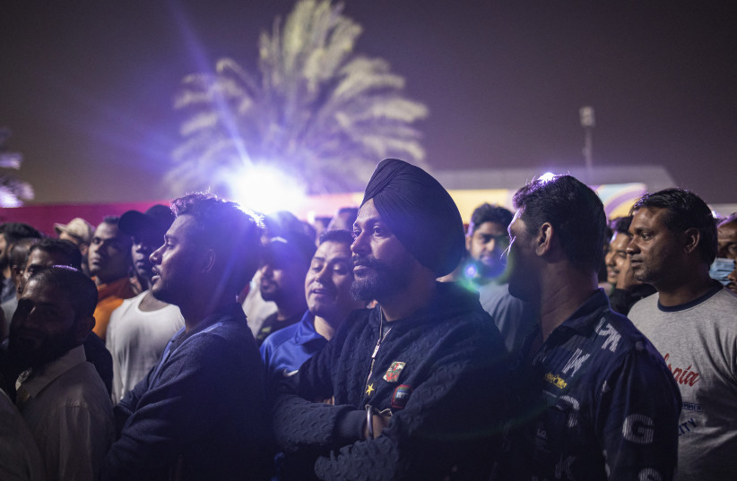 Migrant workers watch Qatar v. Ecuador at the FIFA World Cup Qatar 2022, Al Khor, Qatar, November 20, 2022 (credit: REUTERS/MARKO DJURICA)