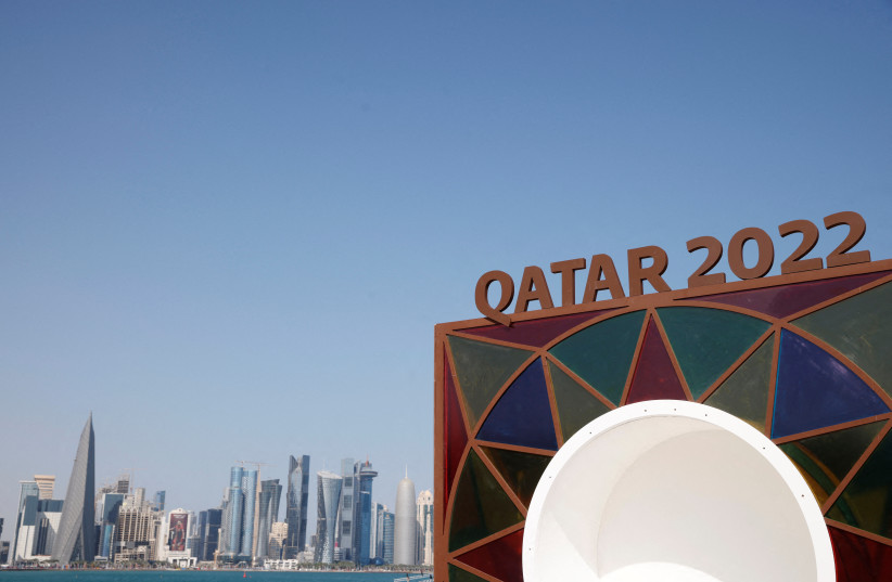 A Qatar 2022 logo is seen in front of the skyline of the West Bay in Doha ahead of the FIFA World Cup, November 10, 2022. (photo credit: REUTERS/JOHN SIBLEY/FILE PHOTO)