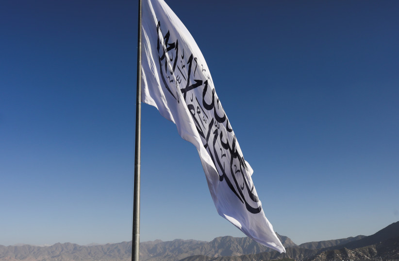  The Taliban flag is seen during the Taliban flag-raising ceremony in Kabul, Afghanistan, March 31, 2022 (photo credit:  REUTERS/ALI KHARA)